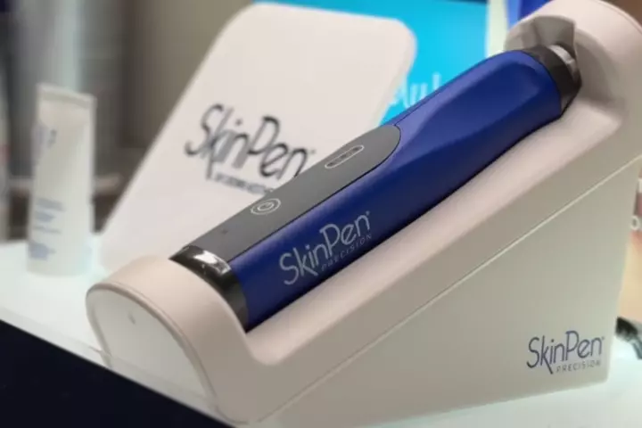 Blue SkinPen Precision device in its charging stand at SOLAÉ